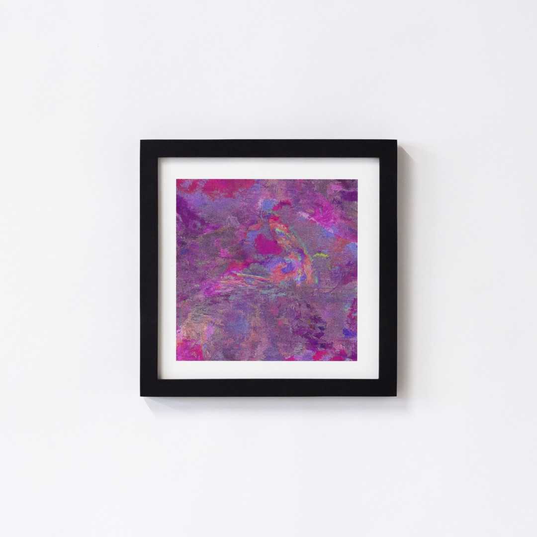 A print of an abstract pink texture in a black frame