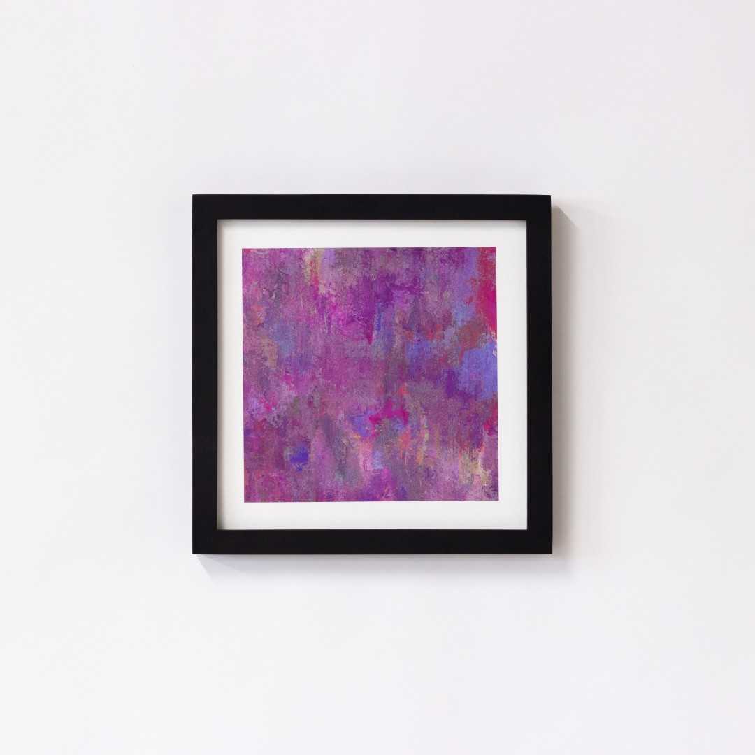 A print of an abstract pink texture in a black frame