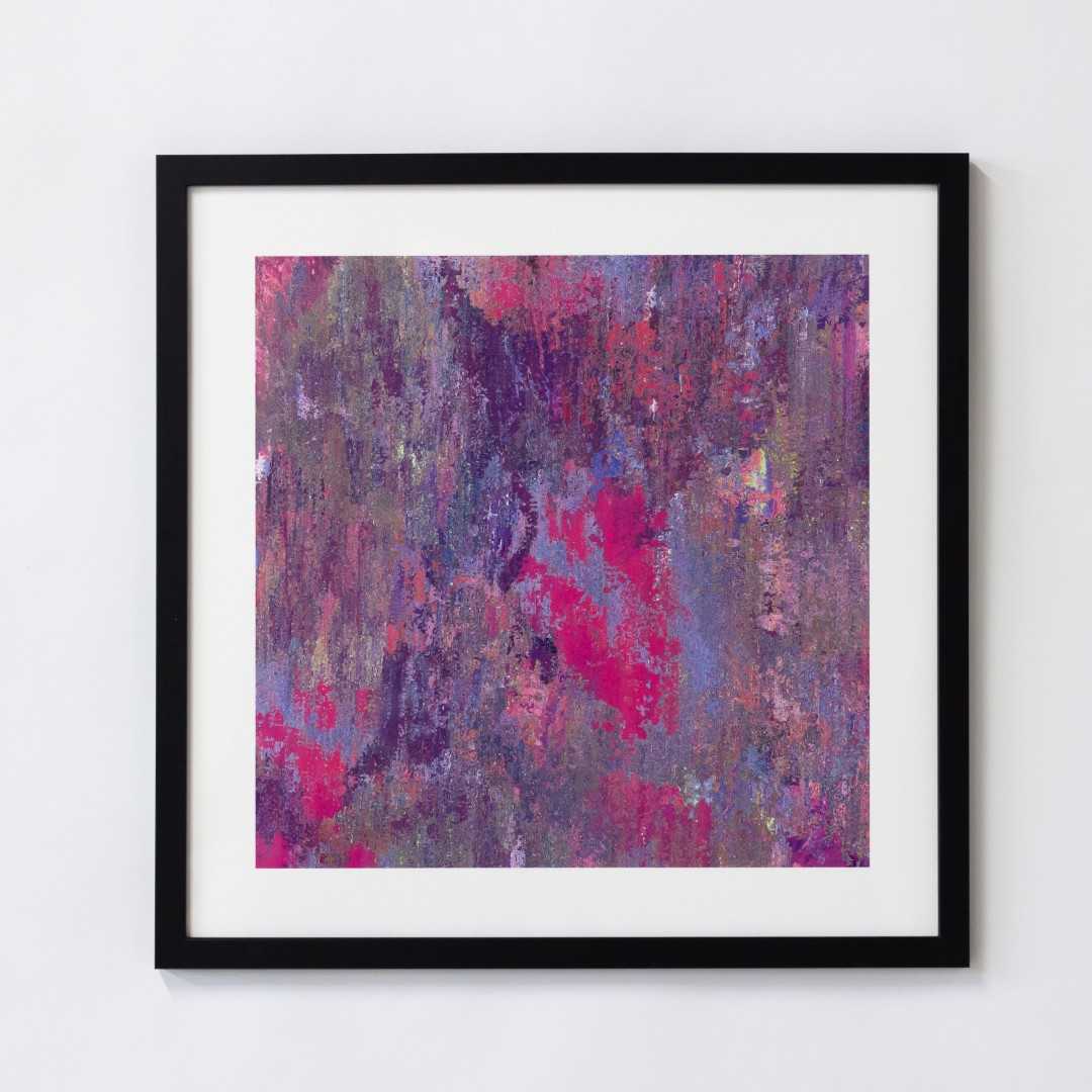 A print of an abstract pink texture in a black frame